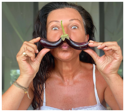 lady holding eggplants mustache