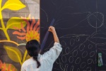 Artist paints mural