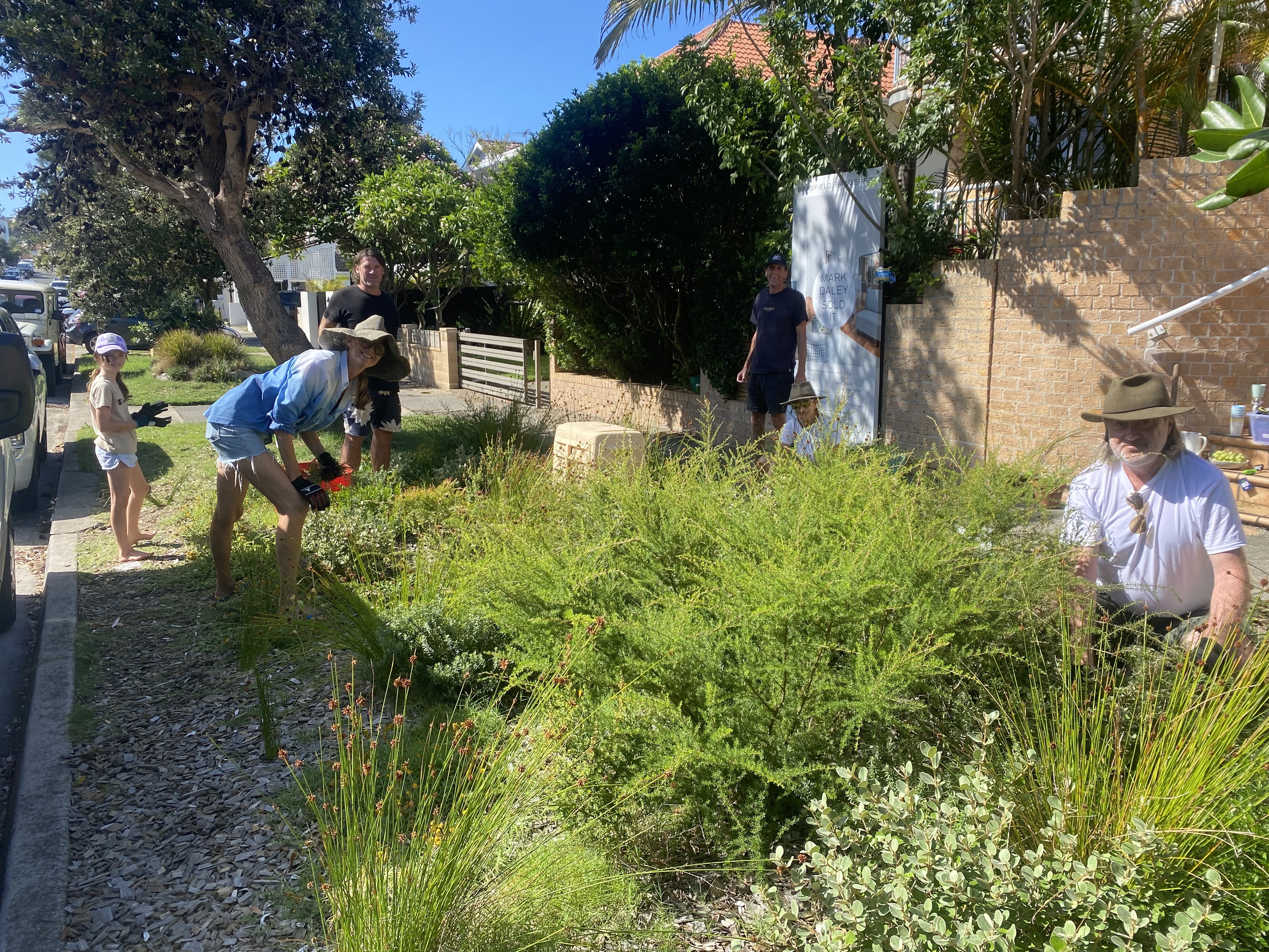 Barbara Verge gardening with group of helpers