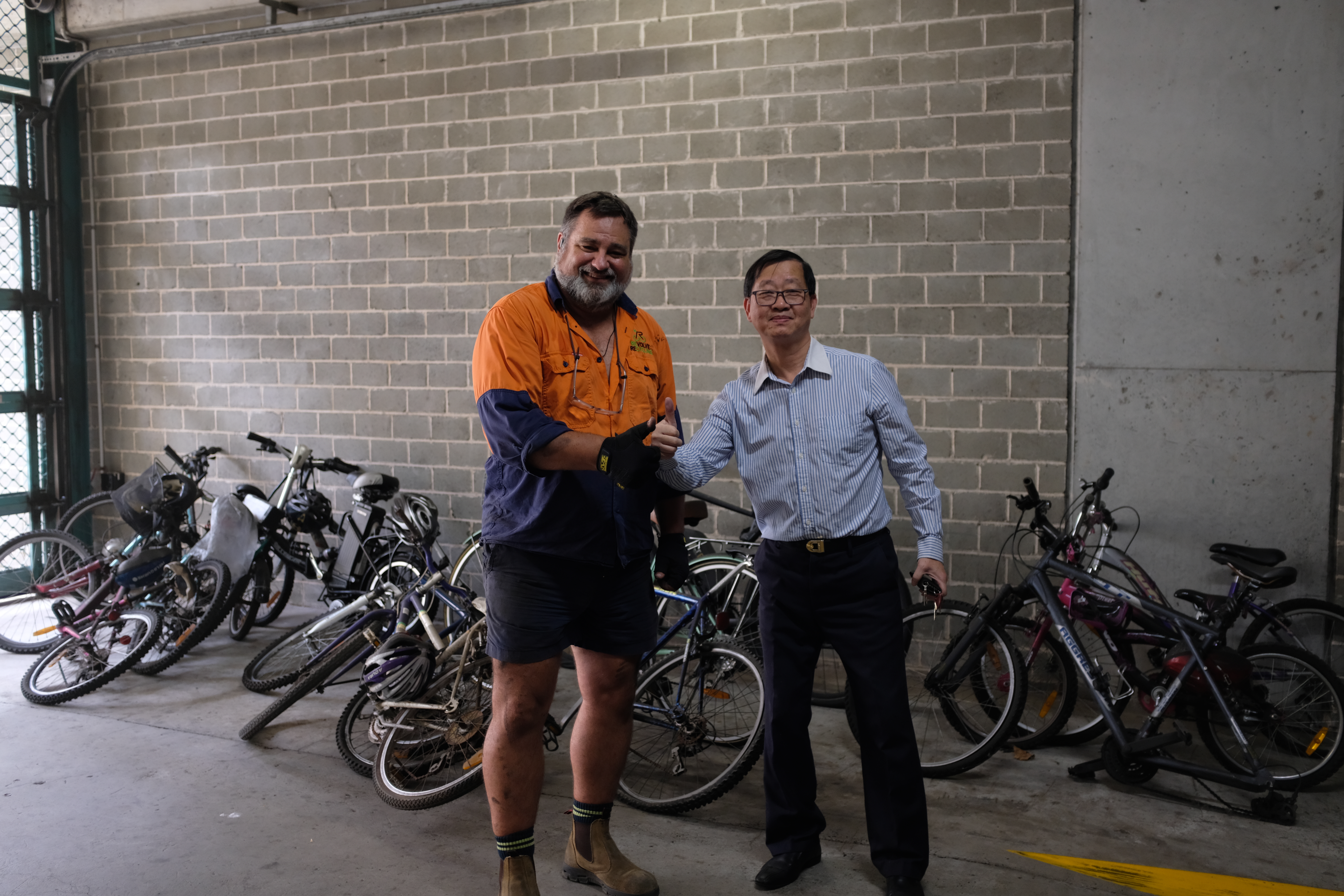 Owner of revolve recylcing and building manager simon in front of bikes