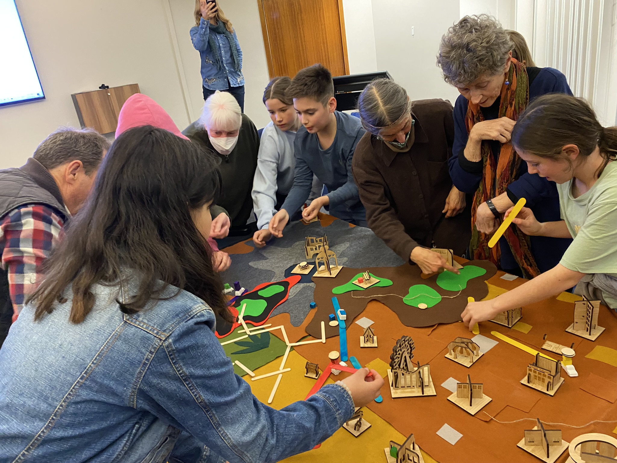 Youth and seniors looking at things on a table