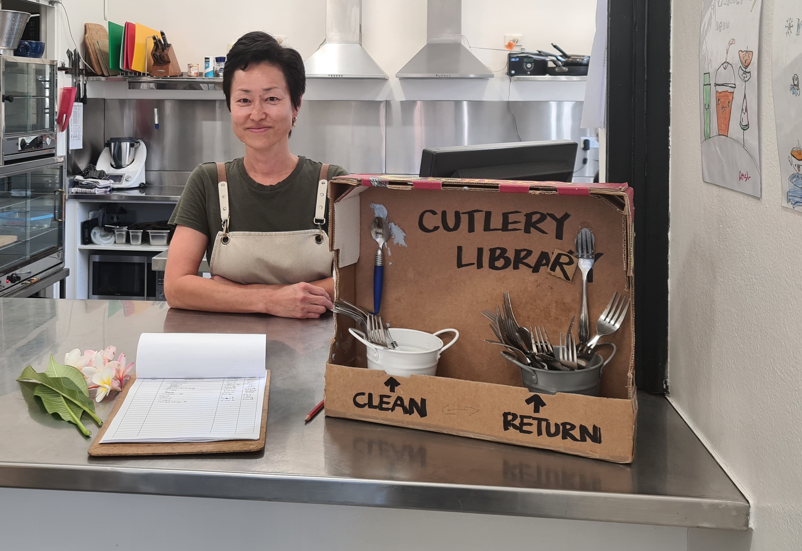 Canteen manager Kai with cutlery library on counter