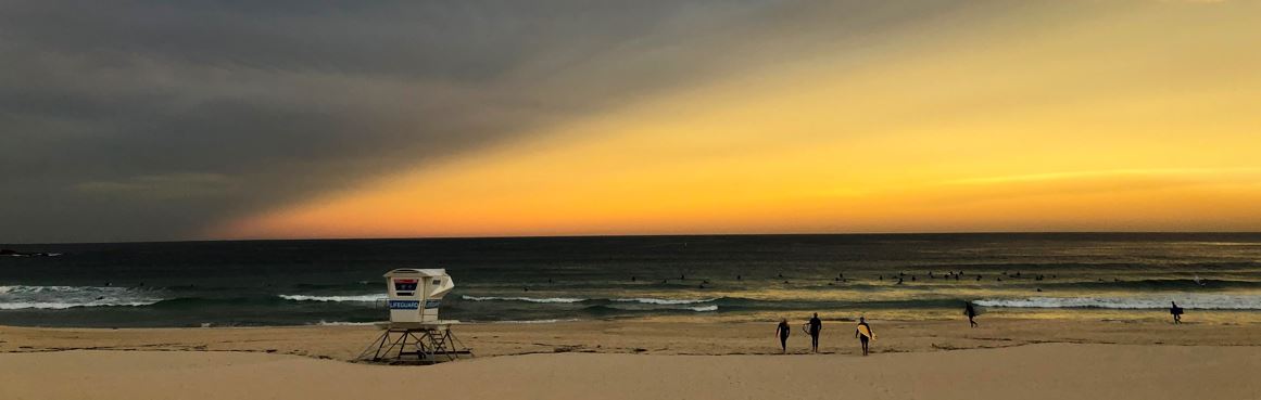 Lifeguard tower surfers and sunrise 