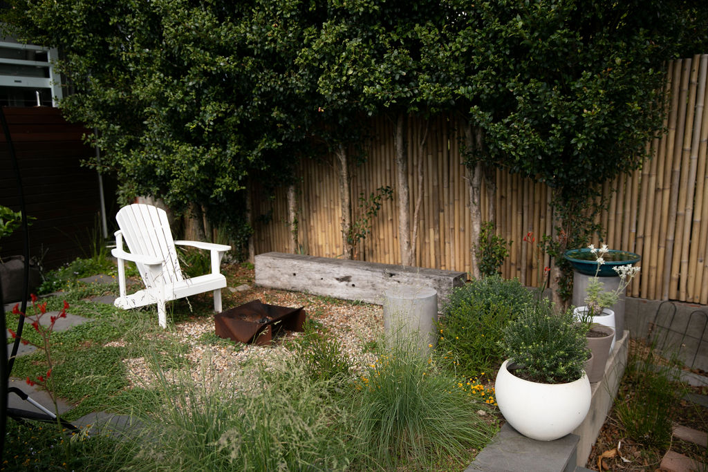 Image showing a seating area wiht firepit with ground covers and native grass.